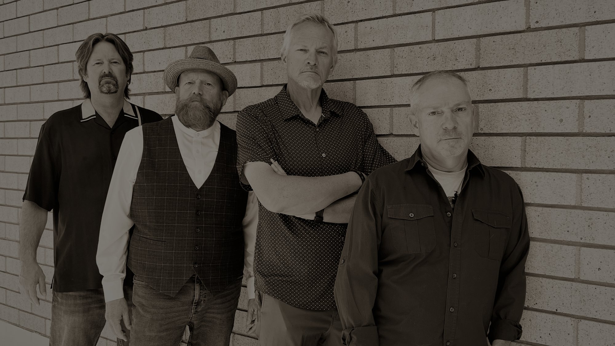 Roadhouse Revival: Matt Lichtenwalter, Dave Thomas, Evan Smith and Tom Hurley against a brick wall.